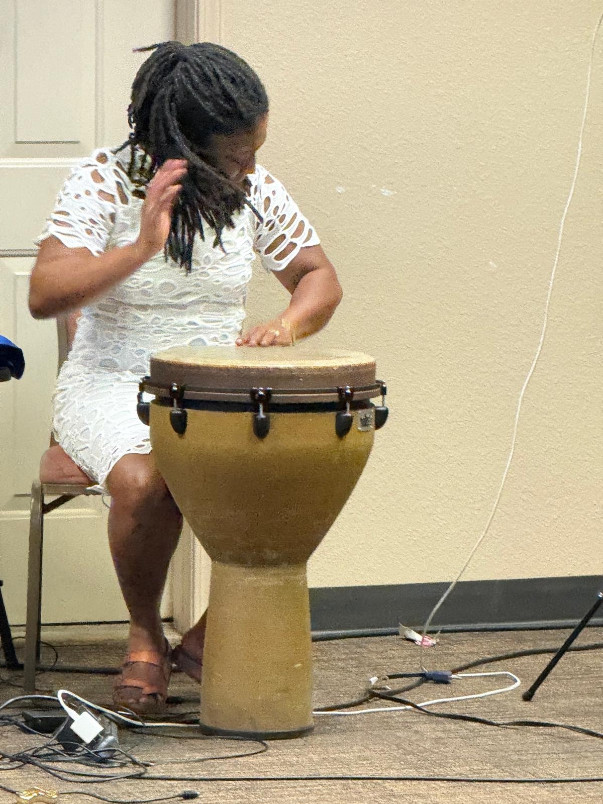 Musician playing djembe at THM